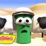 Green VeggieTales character with a hat and surprised expression in a desert scene, flanked by sheep, VeggieTales logo visible.