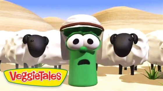 Green VeggieTales character with a hat and surprised expression in a desert scene, flanked by sheep, VeggieTales logo visible.
