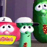 Three VeggieTales characters—a red tomato, a green cucumber wearing white caps, and a tall pickle with a polka-dot tie—pose together with the VeggieTales logo in the corner.