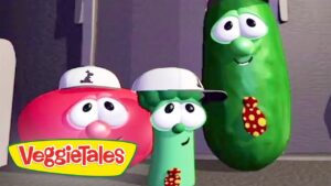 Three VeggieTales characters—a red tomato, a green cucumber wearing white caps, and a tall pickle with a polka-dot tie—pose together with the VeggieTales logo in the corner.