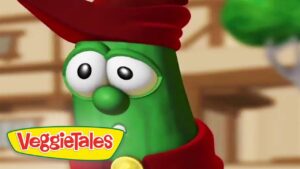 Close-up of a green VeggieTales character with a red hat and yellow logo in the corner.