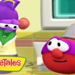 Two VeggieTales characters converse in a bright kitchen, with a computer screen in the background.