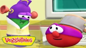 Two VeggieTales characters converse in a bright kitchen, with a computer screen in the background.