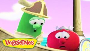 Green cucumber character in a pirate hat consoles a surprised red tomato on a wooden VeggieTales ship with a pink sky.