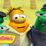 Three VeggieTales characters pose together with the show’s logo in the corner, smiling at the camera.