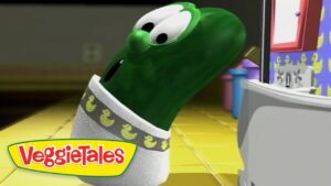 Green VeggieTales character tilts head and looks toward a computer screen in a bright, yellow-tiled room; VeggieTales logo shown bottom-left.