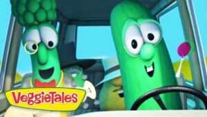 Two cheerful green veggie characters drive a car, with a steering wheel in front of them and the VeggieTales logo on the lower-left corner.
