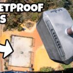 Aerial view of a rooftop with a bold 'BULLETPROOF GLASS' title and a white arrow pointing to the roof.