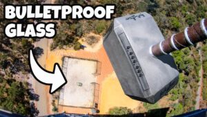 Aerial view of a rooftop with a bold 'BULLETPROOF GLASS' title and a white arrow pointing to the roof.
