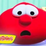 Close-up of a shocked, red VeggieTales character with wide eyes and open mouth. Logo visible in the bottom-left corner.