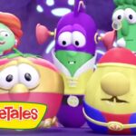 Group of VeggieTales characters posing together on a colorful stage with the VeggieTales logo in the corner.