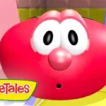 Red round cartoon character with big white eyes and surprised expression, VeggieTales logo in the bottom-left corner.