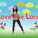 Young girl dancing in a colorful cartoon landscape with the words 'Love the Lord'.