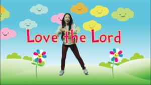 Young girl dancing in a colorful cartoon landscape with the words 'Love the Lord'.