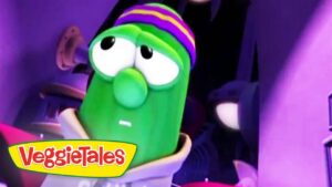 Green VeggieTales character with a striped purple-yellow hat in a purple-lit scene, VeggieTales logo at bottom left.