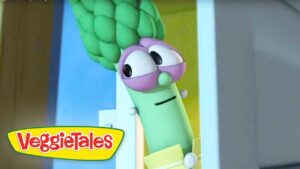 Cartoon green vegetable from VeggieTales peeking through a doorway, with purple glasses and a sleepy expression.