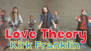 Group of kids dancing in a studio with bold red-and-white title text 'Love Theory' and yellow 'Kirk Franklin' overlay.