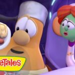 VeggieTales scene with a chef-like carrot presenting a plate of a hot dog and buns while a red-haired character watches.