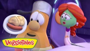 VeggieTales scene with a chef-like carrot presenting a plate of a hot dog and buns while a red-haired character watches.