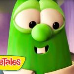 Larry the Cucumber from VeggieTales smiles at the camera, with the VeggieTales logo visible in the bottom-left corner.