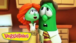 Two green veggie characters in a kitchen, a red-haired female and a green cucumber-like figure, look surprised as they stand near cabinets; VeggieTales logo in the bottom-left corner.