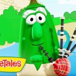 Green VeggieTales character with big eyes plays bagpipes by a riverside, logo in the corner.