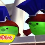 Two green VeggieTales characters with blue helmets peek over a brick wall, VeggieTales logo in the corner.