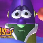 Close-up of a purple cartoon alien with large eyes on a purple space background, with the 'Larryboy: The Cartoon Adventures' logo in the corner.
