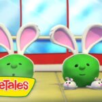 Two green VeggieTales characters with large pink bunny ears stand in a bright room, smiling at the viewer, with small bunny friends nearby and the VeggieTales logo visible.