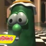 Larry the Cucumber from VeggieTales wearing a head wrap in a checkerboard hallway, VeggieTales logo visible in the corner.