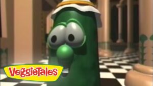Larry the Cucumber from VeggieTales wearing a head wrap in a checkerboard hallway, VeggieTales logo visible in the corner.