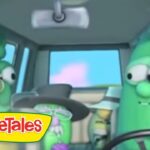 Inside a car, two animated green vegetables from VeggieTales—one on the left wears glasses, the driver on the right, with the VeggieTales logo in the corner.