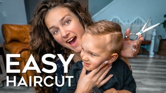 Woman giving a haircut to a smiling young boy; scissors in hand, cozy home setting, with bold white text 'EASY HAIRCUT' on the image
