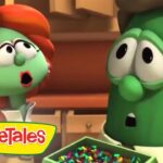 Two VeggieTales characters in a kitchen look surprised as confetti spills from a box, front logo visible.