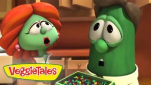 Two VeggieTales characters in a kitchen look surprised as confetti spills from a box, front logo visible.