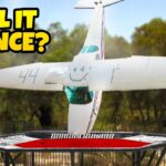 Upside-down small airplane bouncing on a trampoline, with bold 'WILL IT BOUNCE?' text in the corner (video thumbnail).