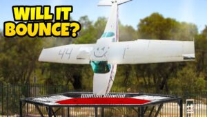 Upside-down small airplane bouncing on a trampoline, with bold 'WILL IT BOUNCE?' text in the corner (video thumbnail).