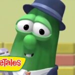 Larry the Cucumber from VeggieTales wearing a blue hat, smiling against a colorful background with the VeggieTales logo in the corner