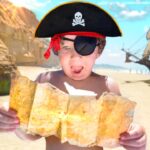 Child on a sunny beach looking at a folded map, wearing a pirate hat and an eyepatch, with a pirate ship in the distance.