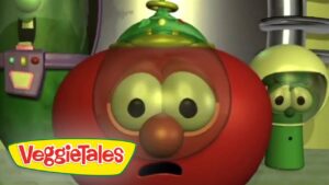 Red tomato character from VeggieTales with wide eyes and open mouth, in a lab-like setting with a VeggieTales logo visible.