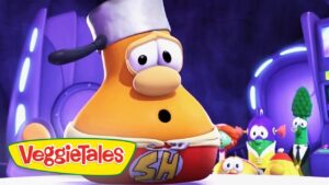 Large orange VeggieTales character wearing a chef's hat on a colorful stage, VeggieTales logo in the corner.