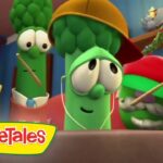 Three animated broccoli characters ride in a vehicle, wearing hats and headphones, VeggieTales logo in the corner.