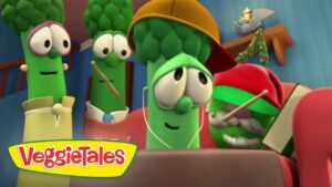 Three animated broccoli characters ride in a vehicle, wearing hats and headphones, VeggieTales logo in the corner.