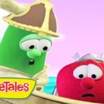 Green VeggieTales character wearing a pirate hat speaks to a worried red tomato on a wooden ship against a pink sky. The VeggieTales logo is in the corner.