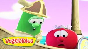 Green VeggieTales character wearing a pirate hat speaks to a worried red tomato on a wooden ship against a pink sky. The VeggieTales logo is in the corner.