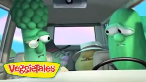 Two VeggieTales charactersβa broccoli driver and a cucumber passengerβare riding in a car, with the VeggieTales logo visible in the lower left corner.