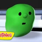 Green VeggieTales character with a surprised expression, in a white setting, VeggieTales logo in the corner