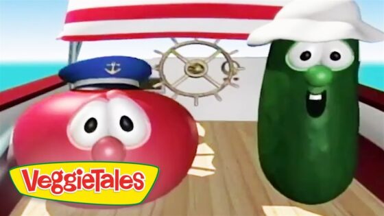 Two VeggieTales characters, a red tomato and a green cucumber, on a ship deck with a steering wheel and logo in the foreground.