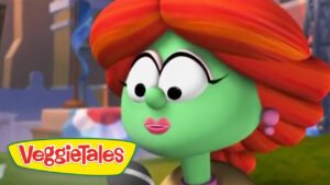 Close-up of a green-skinned VeggieTales character with red hair and pink lips, logo visible in the bottom-left corner.