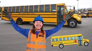 Happy worker in a blue hard hat and orange safety vest raises arms in a bus yard with yellow school buses; cartoon school bus graphic overlays the foreground.